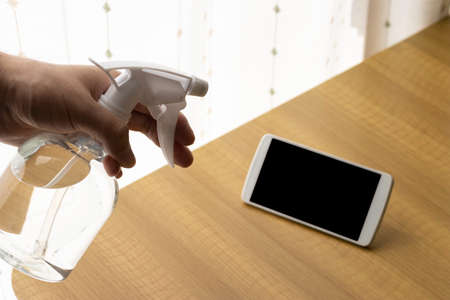 Image of disinfecting smartphones with alcoholの写真素材