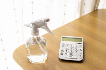 Image of disinfecting a calculator with alcoholの写真素材