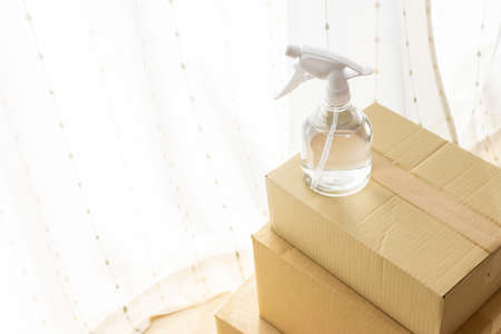 Image of disinfecting cardboard boxes with alcoholの写真素材