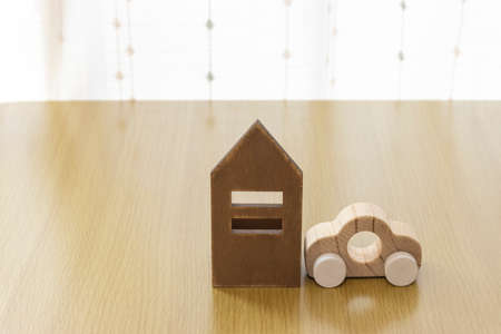 House and car wooden toys on the tableの写真素材