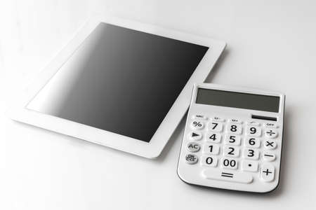 Calculator and tablet device. Digital device cost imageの写真素材