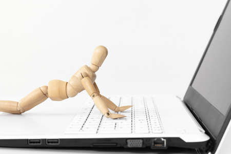 An image of a drawing doll operating a laptop computer. Robotic Process Automation (RPA) Imageの写真素材