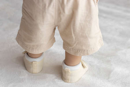 Standing baby's feet wearing baby shoes (1 year and 2 months old, girl, Japanese)の写真素材