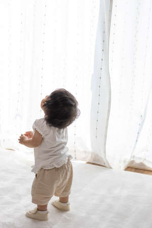 Standing baby wearing baby shoes (1 year and 2 months old, girl, Japanese)の写真素材