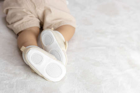 Lying baby's feet in shoes (1 year and 2 months old, girl, Japanese)の写真素材