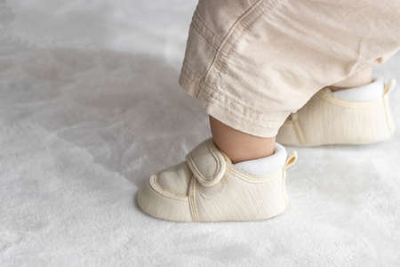 Standing baby's feet wearing baby shoes (1 year and 2 months old, girl, Japanese)の写真素材