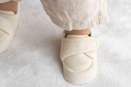 Standing baby's feet wearing baby shoes (1 year and 2 months old, girl, Japanese)の写真素材