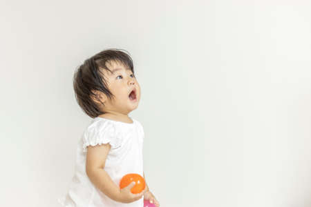 Baby with a Capsule toys (1 year and 2 months old, Japanese, girl)の写真素材