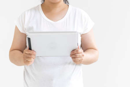 Image of a woman using a tablet device (30s, Japanese, no face)の写真素材