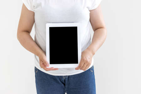 Image of a woman using a tablet device (30s, Japanese, no face)の写真素材