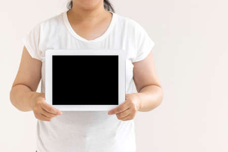 Image of a woman using a tablet device (30s, Japanese, no face)の写真素材