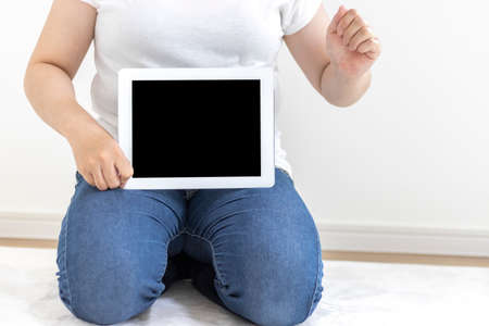 Image of a woman using a tablet device (30s, Japanese, no face)の写真素材