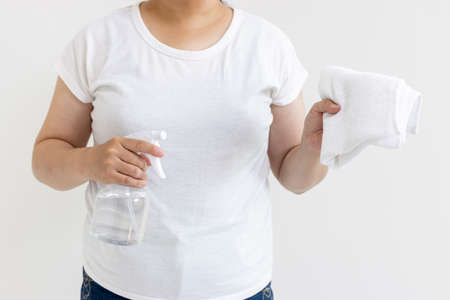 Cleaning image of a woman with a towel and spray (Japanese, 30s, no face)の写真素材