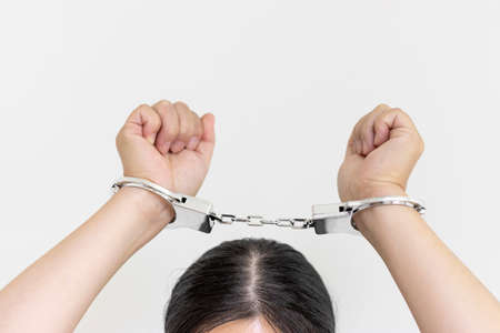 A woman wearing handcuffs (30s, Japanese, no face). Image of arrestの写真素材