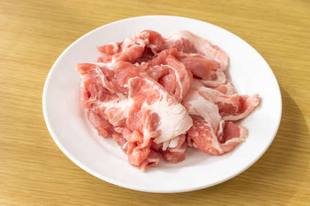 Cut off raw pork on a plateの写真素材
