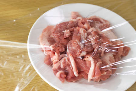 Pork on a plate and wrappedの写真素材