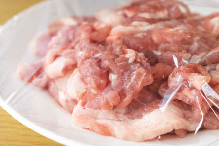 Pork on a plate and wrappedの写真素材