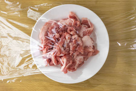 Pork on a plate and wrappedの写真素材