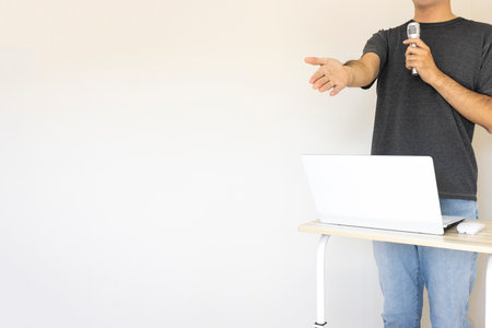 Image of a man giving a presentation (Japanese, 30s, shirt)の写真素材