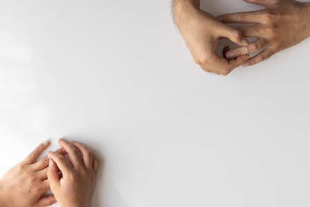 Men's and women's hands to remove the ring. Image of divorceの写真素材