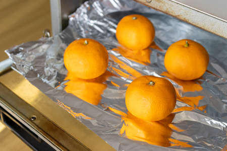 Image of baking oranges in an oven toasterの写真素材