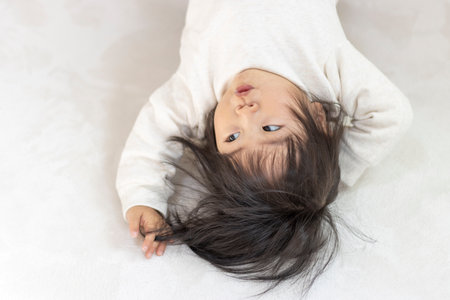 Baby lying down (1 year and 5 months old, Japanese, girl)の写真素材