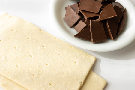 Broken chocolate bar and puff pastry. Image of making chocolate pieの写真素材