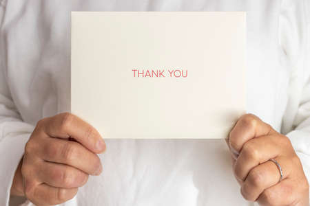 Female with a thank-you letter (30s, Japanese, no face)の写真素材