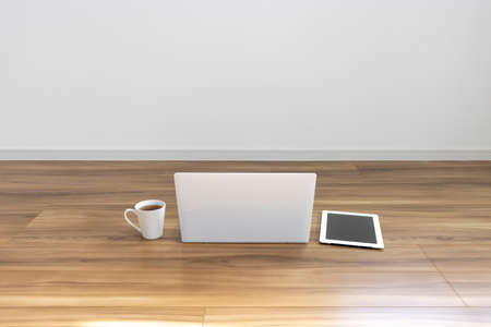 Laptops and tablets on the floor of the houseの写真素材