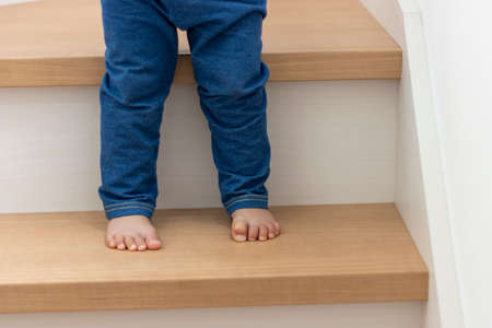 Baby's feet climbing stairs (1 year and 6 months old, girl, Japanese)の写真素材