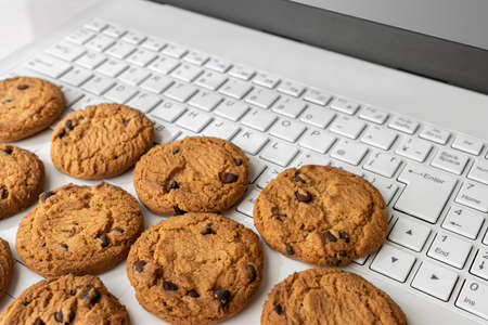 Laptop keyboard and cookies. Digital device cookie image