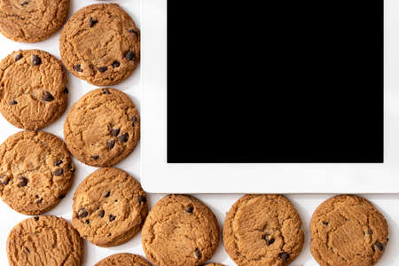 Tablet devices and cookies. Digital device cookie imageの写真素材