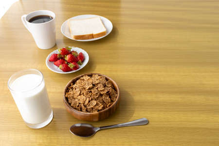Image of breakfast (bread, flakes, strawberries, coffee, milk)の写真素材