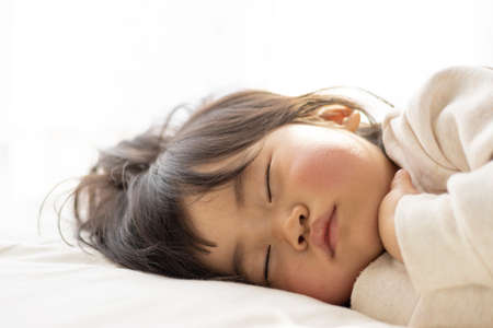 Baby taking a nap on a futon (1 year 8 months old, Japanese, girl)の写真素材