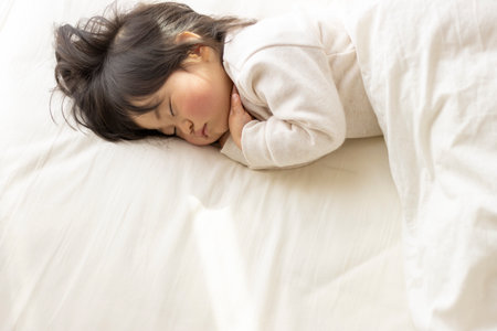Baby taking a nap on a futon (1 year 8 months old, Japanese, girl)の写真素材