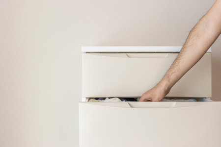A chest placed in the room and a man's hand (30s, no face)の写真素材