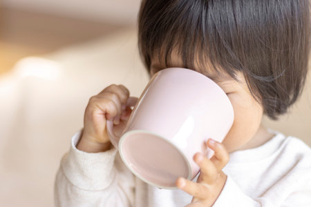 Baby drinking tea with a cup (1 year 9 months old, girl, Japanese)の写真素材