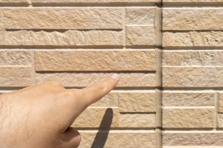 Image of a man inspecting caulking on the outer wallの写真素材