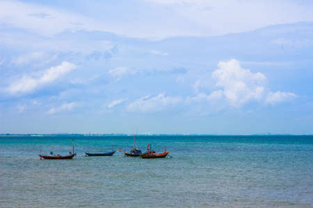 Fishing boats parked in the blue sea.