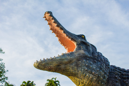 Statue the crocodile jaws and a cloudy sky.の写真素材
