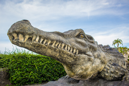 Statue the crocodile jaws and a cloudy sky.の写真素材