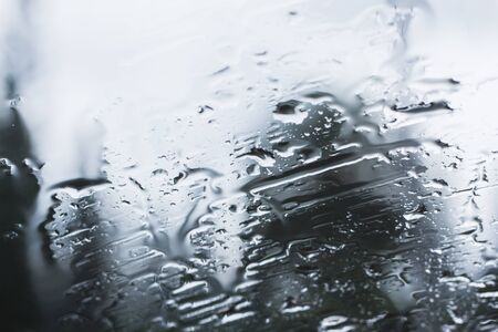 Raindrops on glass during the rainy season.