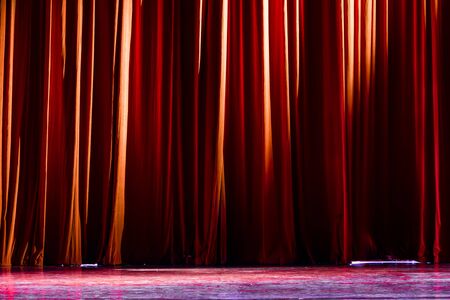 Red curtains and the spotlight in the Theater between shows.の写真素材