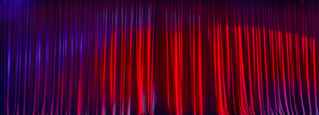 Red curtains panorama closed and the lights to a scene.の写真素材