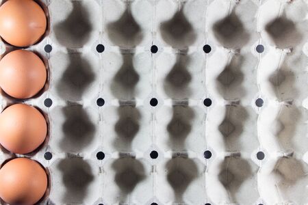 Fresh eggs from the farm in the panel white paper. Background eggs arranged in panels paper. Eggs...