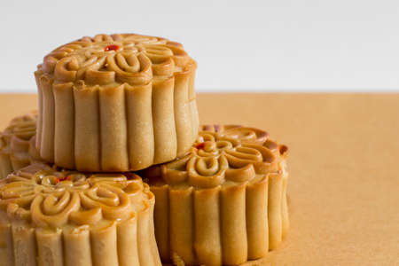 Mooncakes in the Mid autumn Festival. Mid autumn festival mooncake isolated on white and brown...