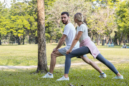 Young Caucasian couples exercise together in the park.の写真素材