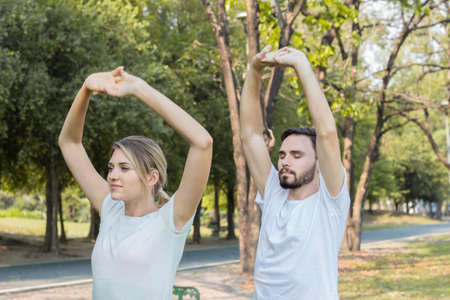 Couples are exercising in the park.の写真素材
