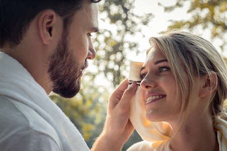 Young man wiped the sweat for his girlfriend after exercising together with tenderness. Concept...