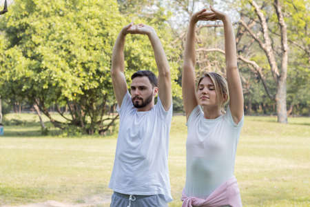 Couples are exercising in the park.